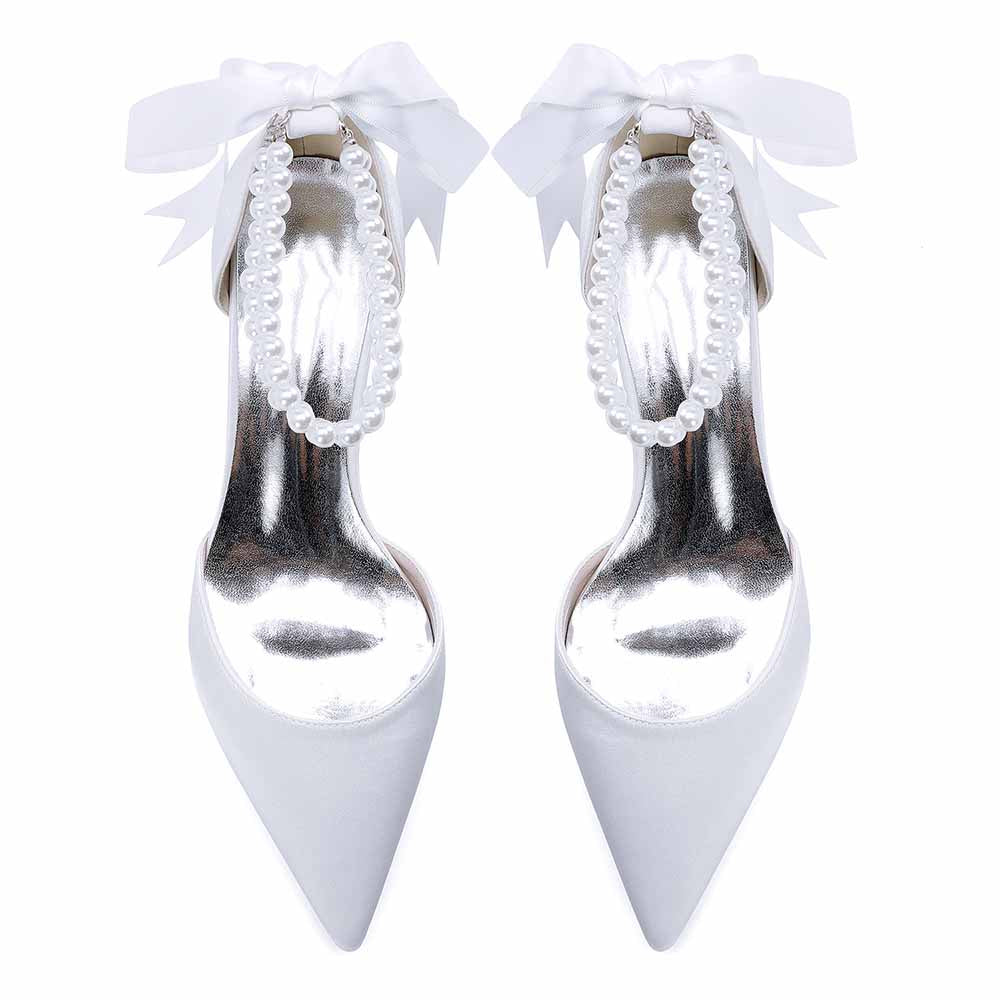 Elegant closed toe wedding heels for bride featuring pearl detailing and satin bow for a chic look