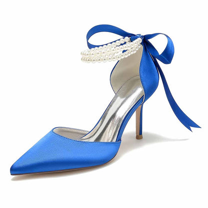 Elegant closed toe wedding shoes in blue satin with a pearl and ribbon detail for stylish brides