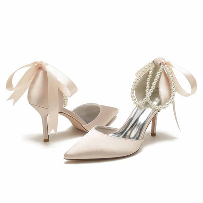 Closed toe wedding shoes with pearl details and satin ribbon bows for elegant bridal styles