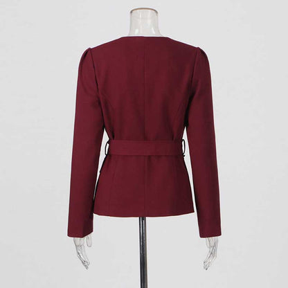 Back view of collarless women's midi skirt set in burgundy with belt detail and structured sleeves