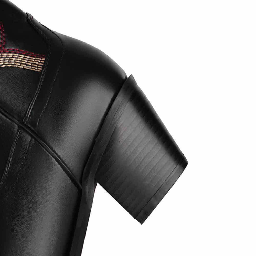 Close-up of colorful embroidered cowgirl boots showcasing detailed stitching and stylish design