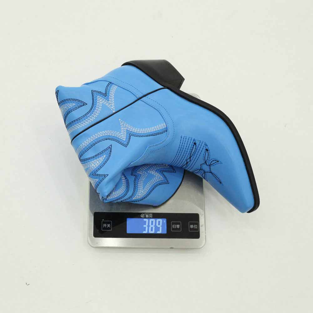 Colorful embroidered cowgirl boots in blue on a scale showing weight of 389 grams