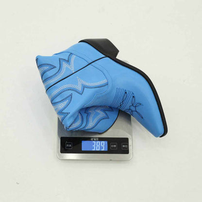 Colorful embroidered cowgirl boots in blue on a scale showing weight of 389 grams