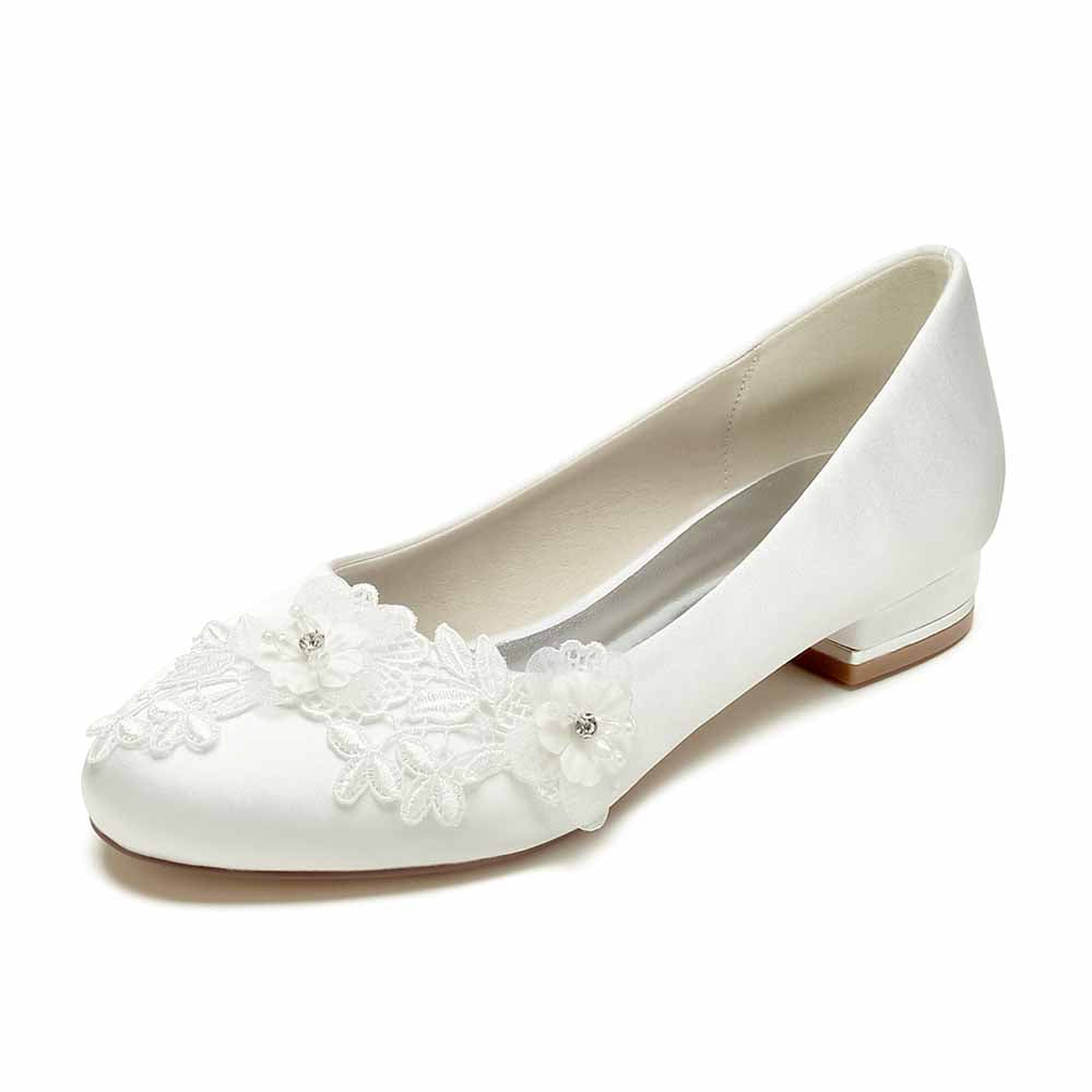 Elegant white comfortable wedding flats for bride with floral embellishments and a low heel 