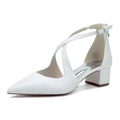 Elegant white cross strap bridal shoes with a pointed toe and block heel for stylish weddings