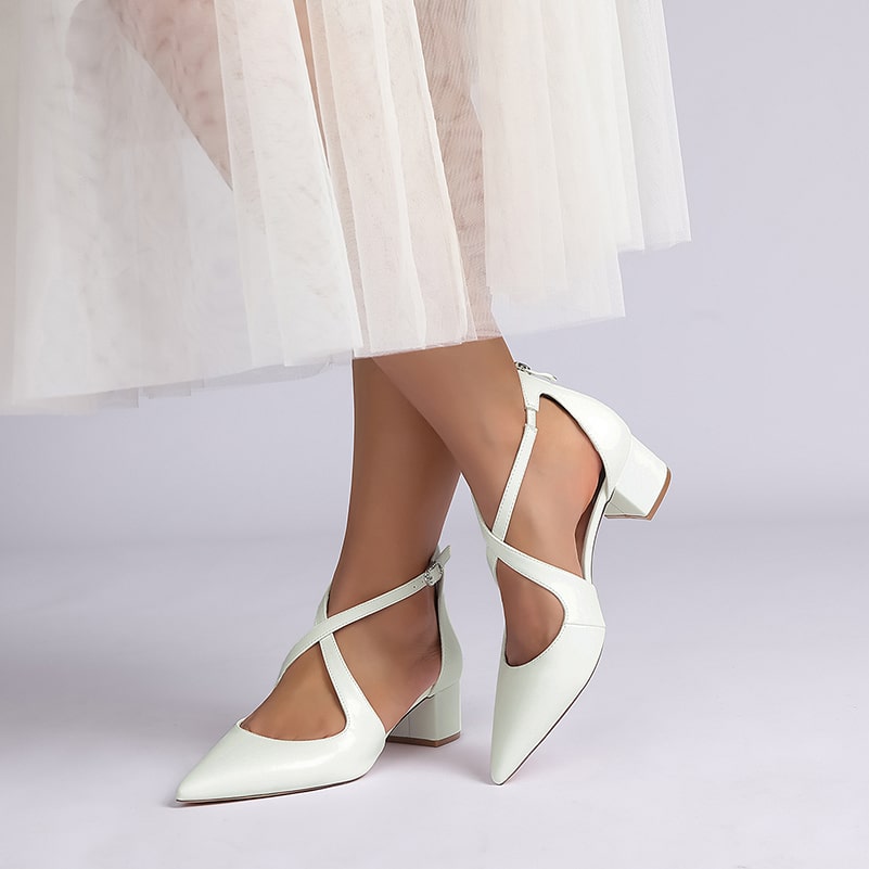 Elegant white cross strap bridal shoes with a pointed toe and block heel for stylish comfort