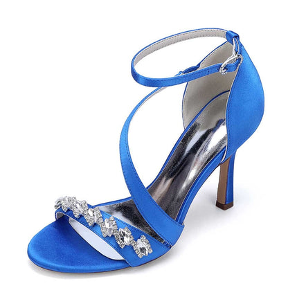 Elegant blue cross-strap wedding shoes for brides with decorative embellishments and a stylish heel.