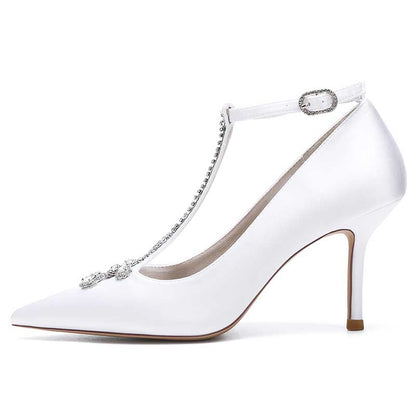 Elegant crystal ankle strap wedding heels in white with a pointed toe and shimmering embellishments