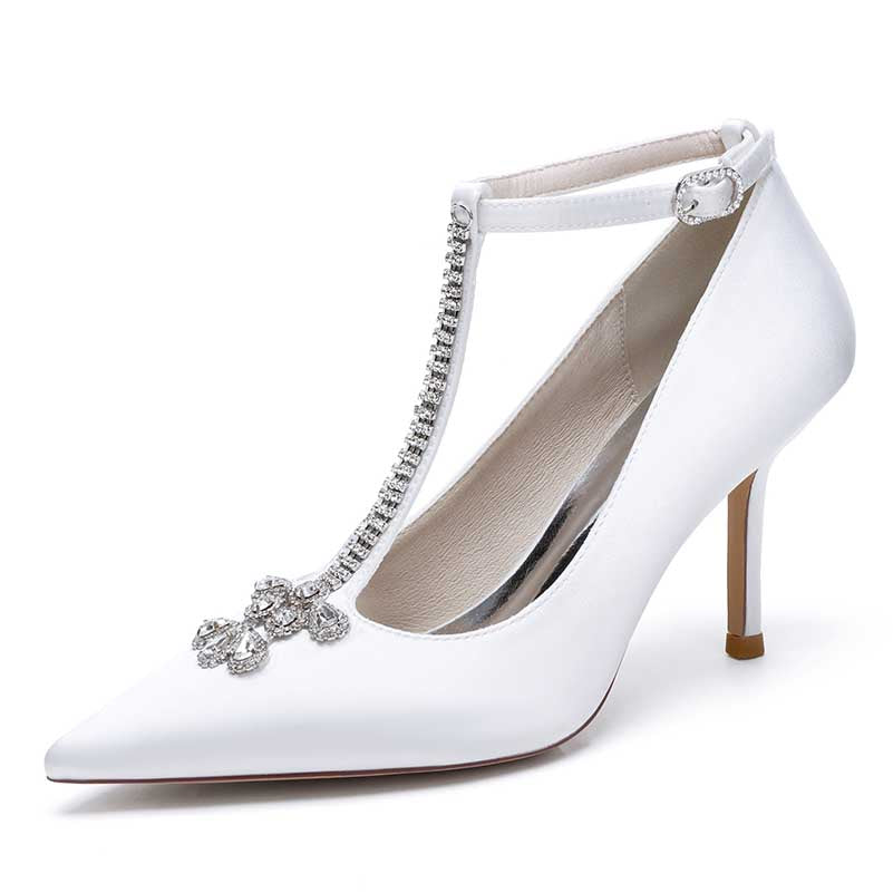 Elegant white crystal ankle strap wedding heels with pointed toe and decorative embellishments