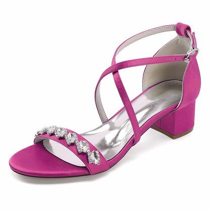 Stylish pink crystal chunky heel dress sandals with a striking strap design and silver embellishments