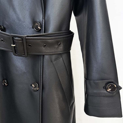 Close-up of a double breasted faux leather trench coat featuring a stylish belt and detailed buttons