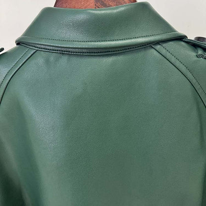 Back view of a trendy double breasted faux leather trench coat in green with stylish detailing