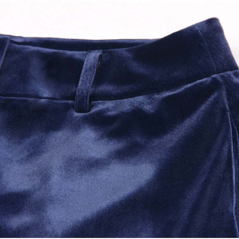 Navy blue detail of a double breasted velvet pantsuit showcasing the smooth fabric texture