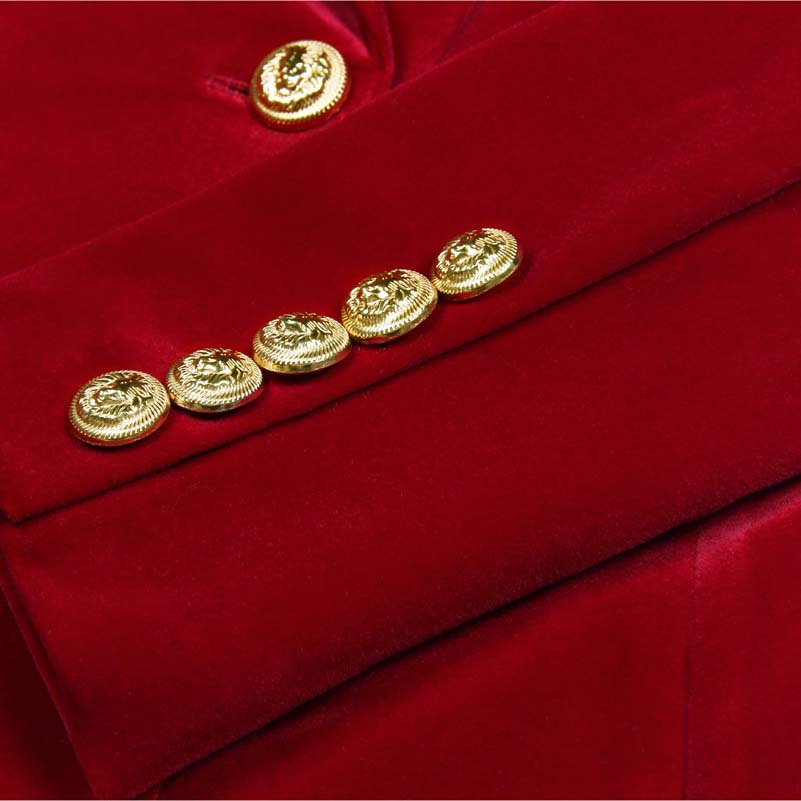 Close-up of gold buttons on a red double breasted velvet pantsuit by SD Dresscode & Fashiontrends