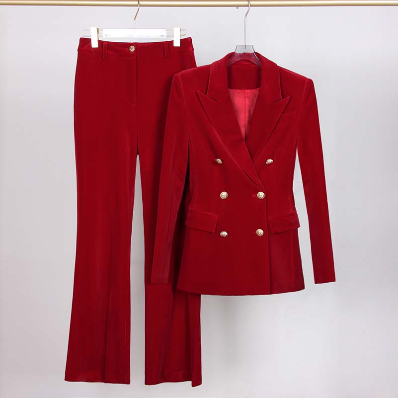 Red double breasted velvet pantsuit featuring a tailored blazer and flared trousers