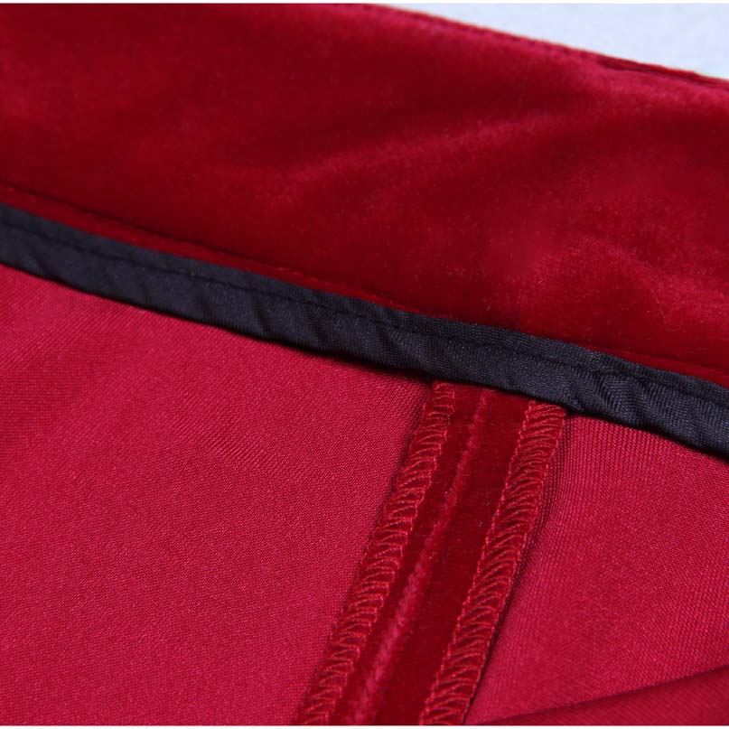 Close-up view of a red double breasted velvet pantsuit showcasing luxurious fabric detailing