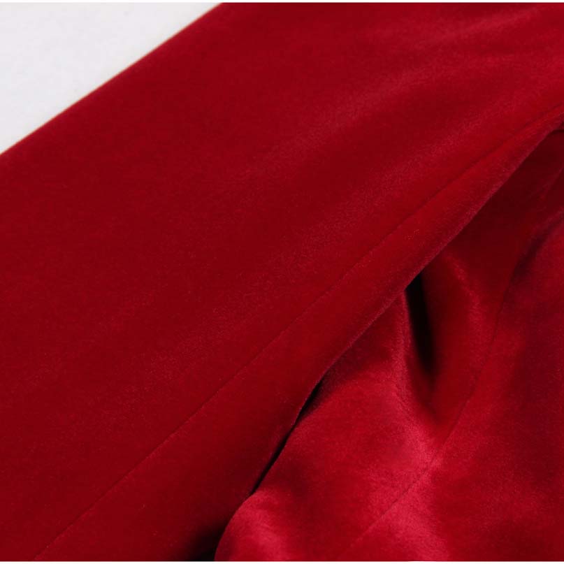 Close-up of the rich red fabric in a double breasted velvet pantsuit, showcasing its luxurious texture