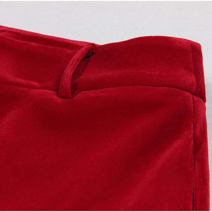 Close-up of the waistband of a red double breasted velvet pantsuit showcasing luxurious fabric texture