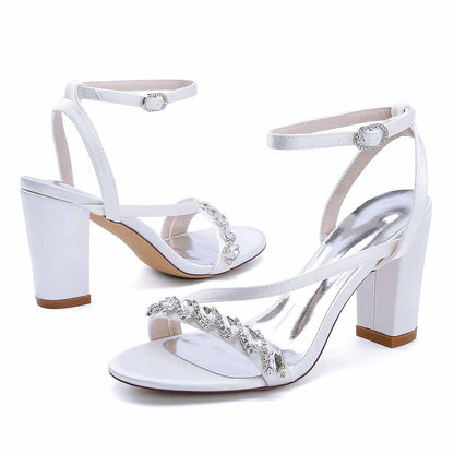 Elegant ankle strap dress shoes in white with decorative rhinestones and block heels