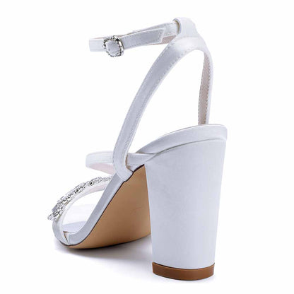 Elegant ankle strap dress shoes in white with a stylish high heel and decorative embellishments