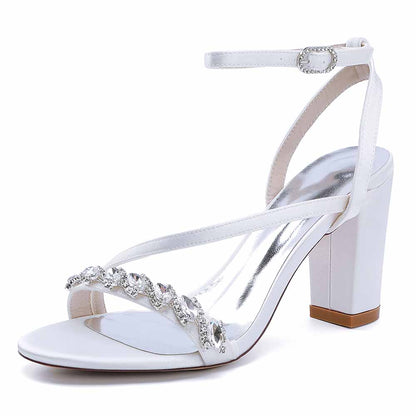 Elegant ankle strap dress shoes in white with crystal embellishments and a block heel