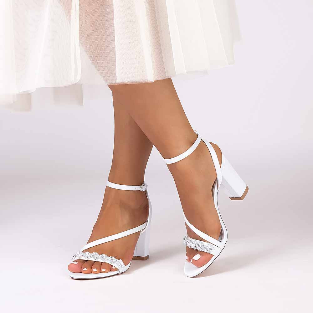 Elegant ankle strap dress shoes in white with strap detailing and a block heel for formal occasions