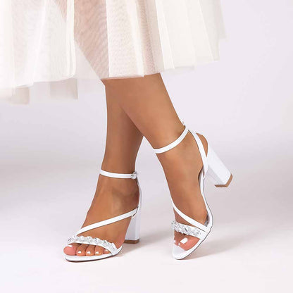 Elegant ankle strap dress shoes in white with strap detailing and a block heel for formal occasions