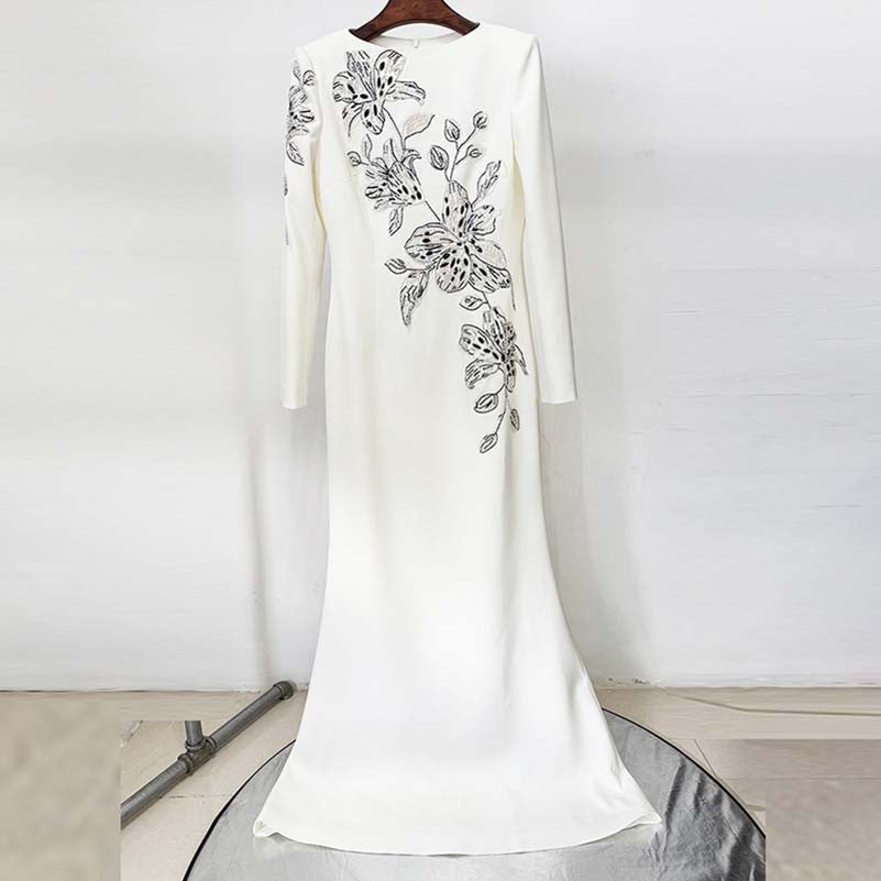 Elegant white embellished evening gown for prom featuring intricate floral embroidery on the side