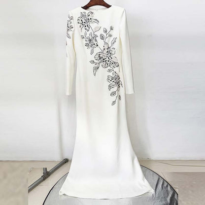 Elegant white embellished evening gown for prom featuring intricate floral embroidery on the side