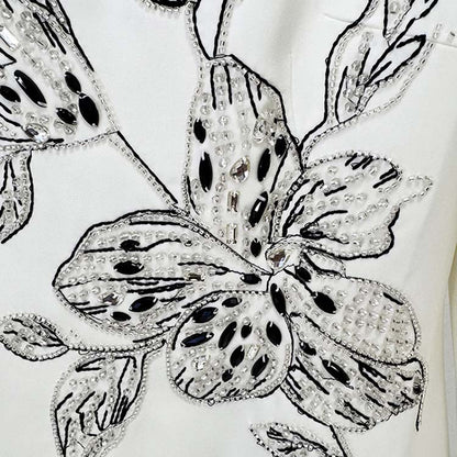 Embellished evening gown for prom featuring intricate floral beadwork and sequins design