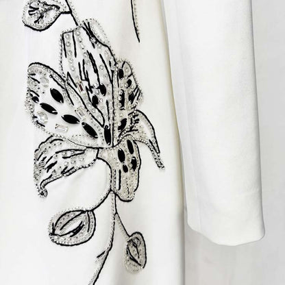 Embellished evening gown for prom featuring elegant floral embroidery and intricate beading detail