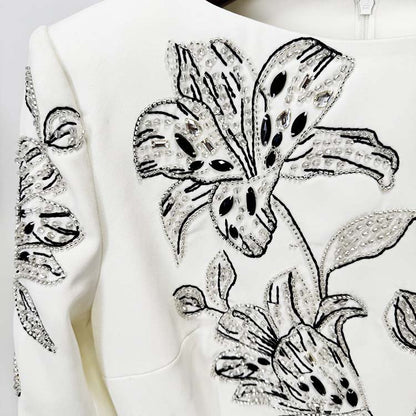 Embellished evening gown for prom with detailed beadwork and floral design on the bodice