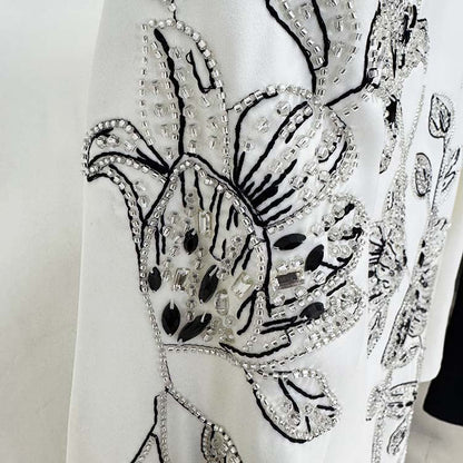 Close-up of an embellished evening gown for prom featuring intricate beaded floral designs