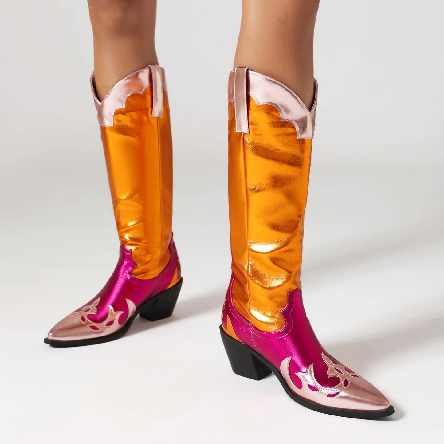Colorful festival cowgirl boots for women in pink and orange with stylish design details