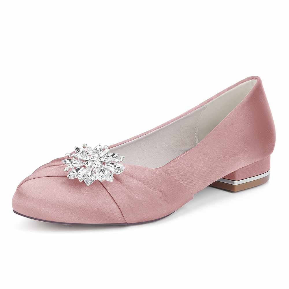 Elegant pink flat wedding shoes for bride featuring a sparkling crystal embellishment