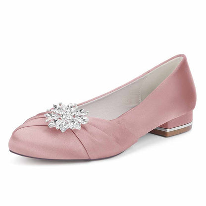 Elegant pink flat wedding shoes for bride featuring a sparkling crystal embellishment