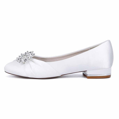 Elegant white flat wedding shoes for bride with jeweled embellishment for a timeless look
