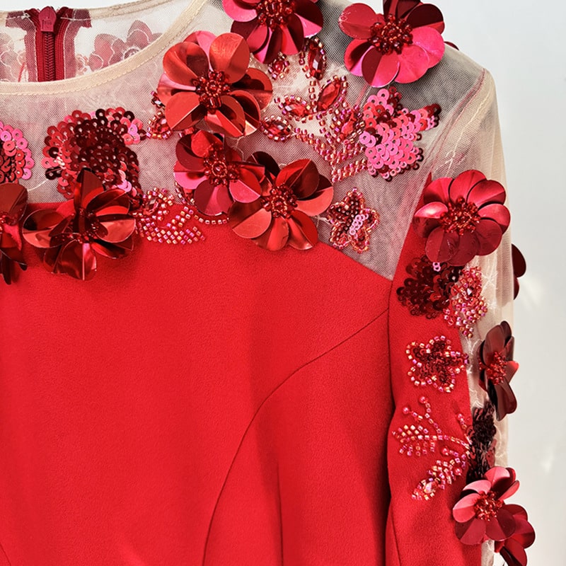 Red floral embellished formal gown with intricate floral embellishments and shimmering details