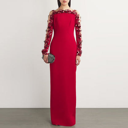 Red floral embellished formal gown with long sleeves and intricate floral detailing for elegant occasions