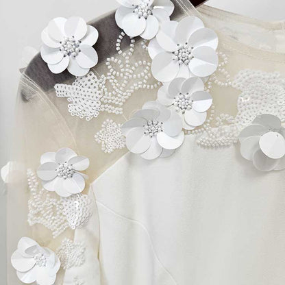 Floral embellished formal gown with intricate white flower details on the shoulder for elegant occasions