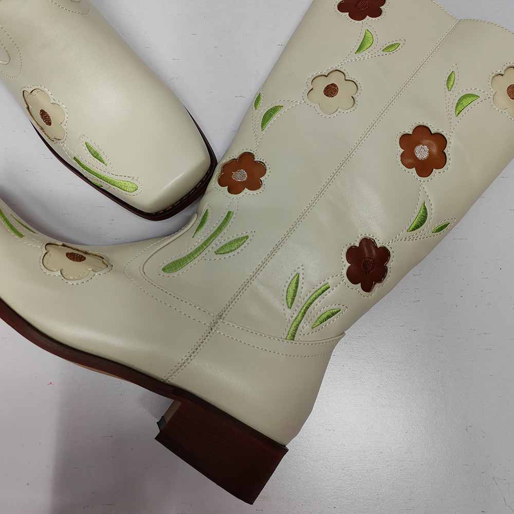 Cream floral embroidered boots with colorful flower designs, perfect for stylish outfits