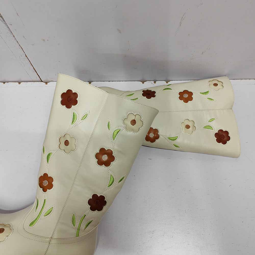Floral embroidered boots in cream color featuring colorful flower designs for a stylish look