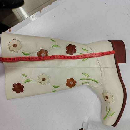 Stylish floral embroidered boots in cream color with colorful floral designs on the shaft