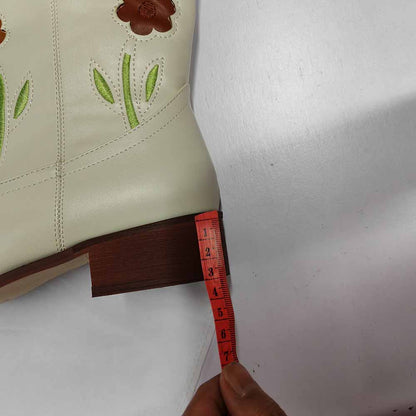 Floral embroidered boots with a cream exterior and detailed flower design on the shaft