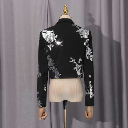 Back view of a black floral sequin crop top skirt set with stylish floral embellishments