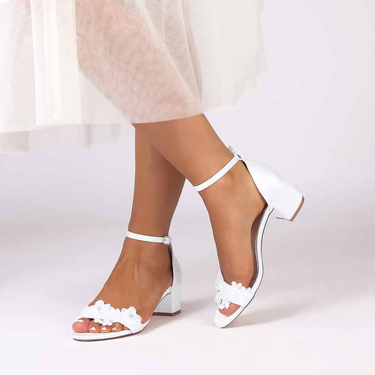 Elegant white flower appliqué wedding shoes with ankle strap and a low block heel