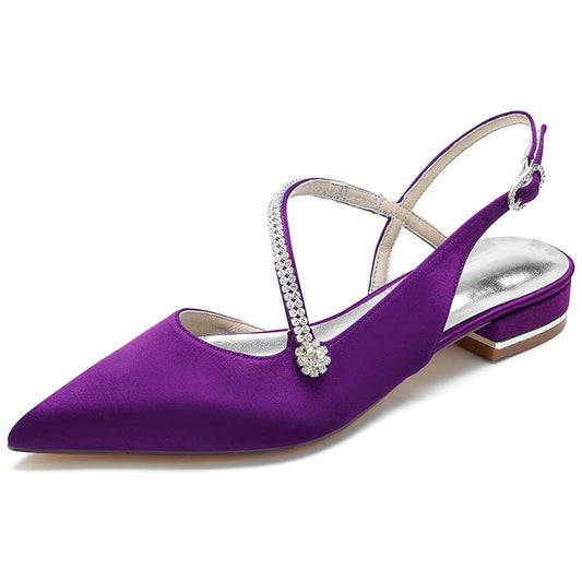 Purple shoe with a stiletto heel and rhinestone strap on a white background
