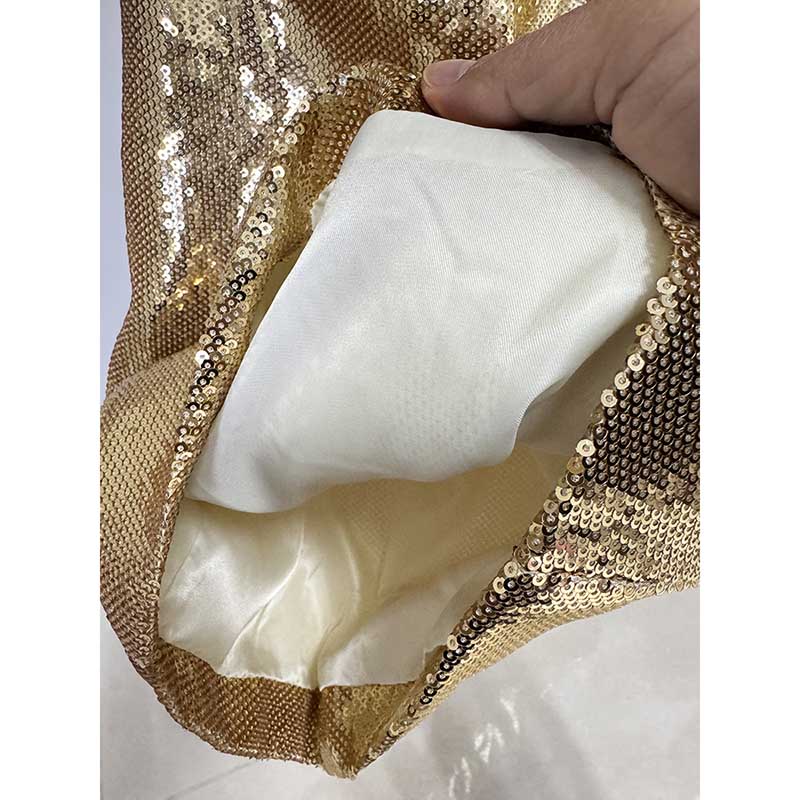 Inside view of gold sequin blazer pantsuit for women showing soft lining and sequined exterior
