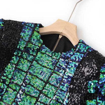 Close-up of a green sequin mini dress with a shimmering pattern and elegant neckline detail