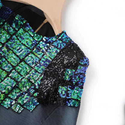 Close-up of a green sequin mini dress showcasing a sparkling sequin design with various shades of green